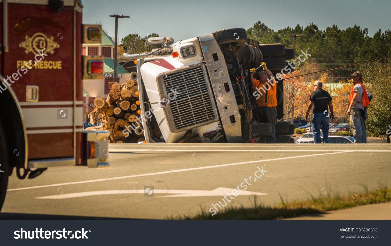 stock-photo-carrboro-nc-us-march-men-working-on-overturned-logging-truck-with-fire-truck-standing-by-790886503 FPO for client approval